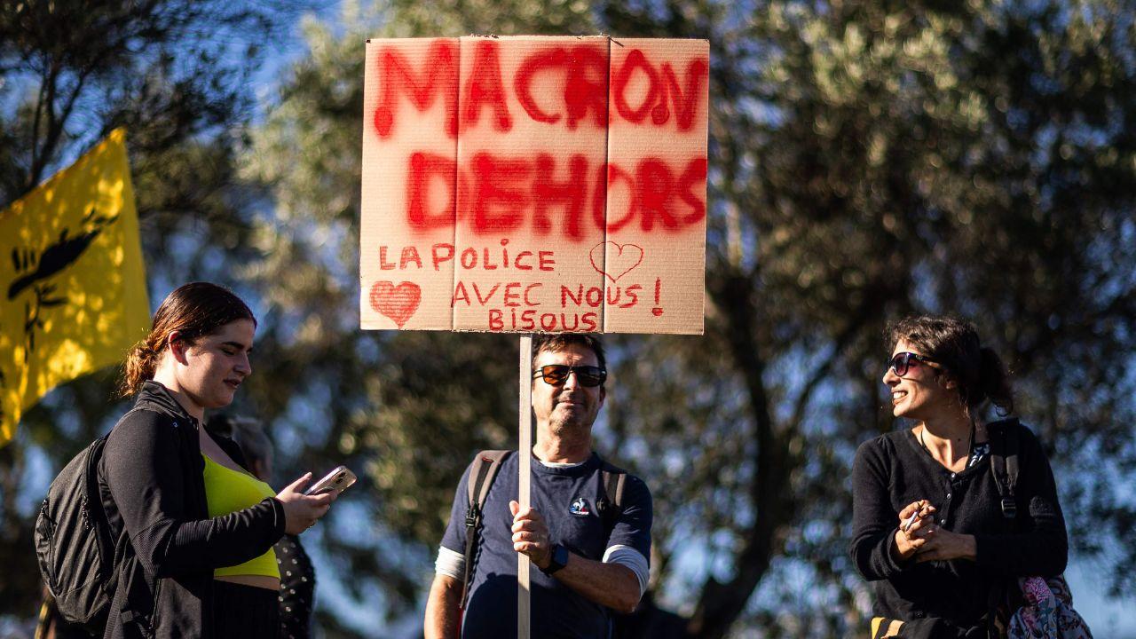 Protesters, one holding a placard reading 
